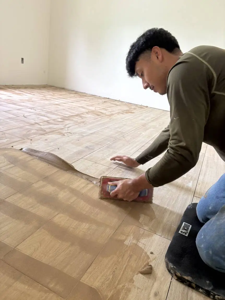 Grouting a wood-look plank tile floor on a Lakeland FL job