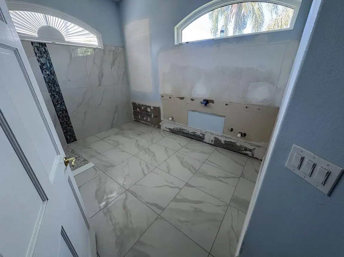 Marble-look porcelain floor tile running into the shower during a Lakeland FL bathroom remodel