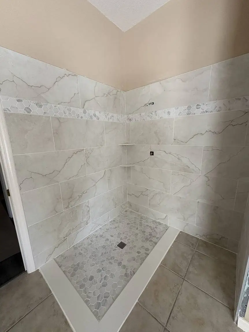 Marble-look porcelain shower with hexagon mosaic accent band and matching mosaic floor, Brandon FL