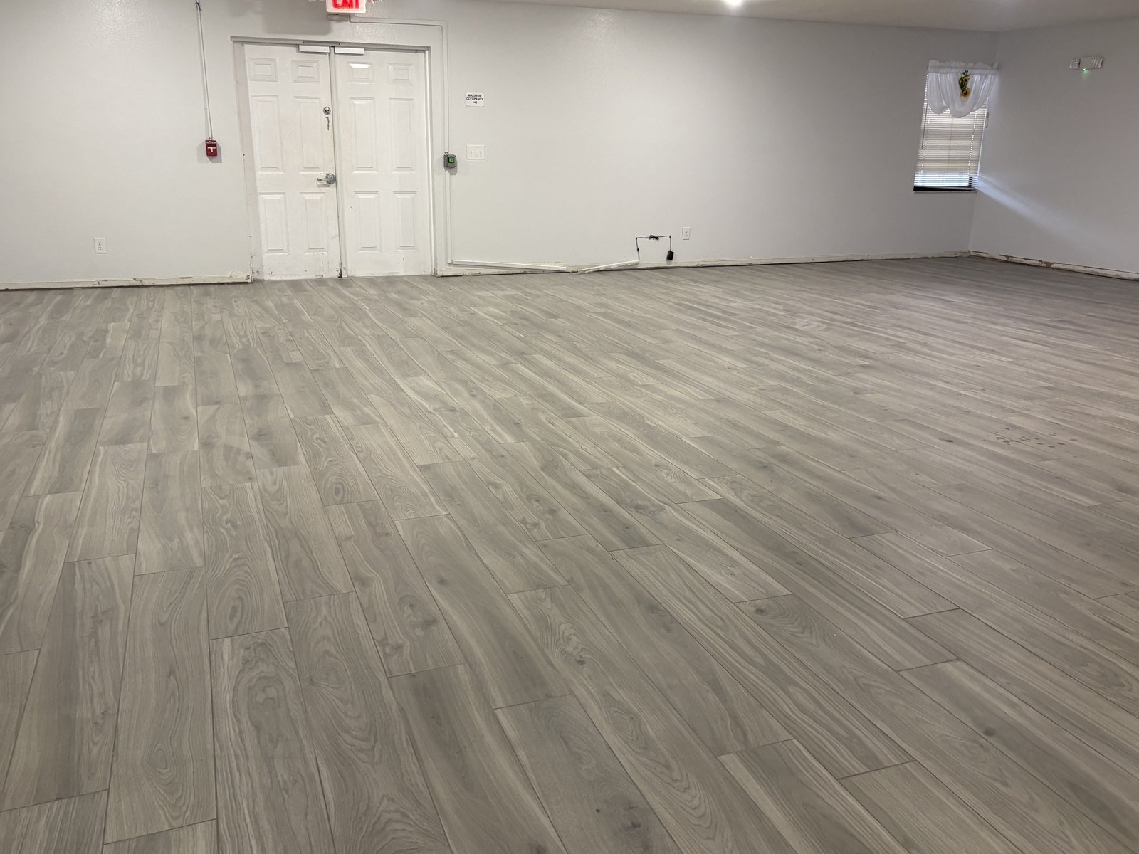 Finished plank flooring and clean transitions in a Plant City church hall