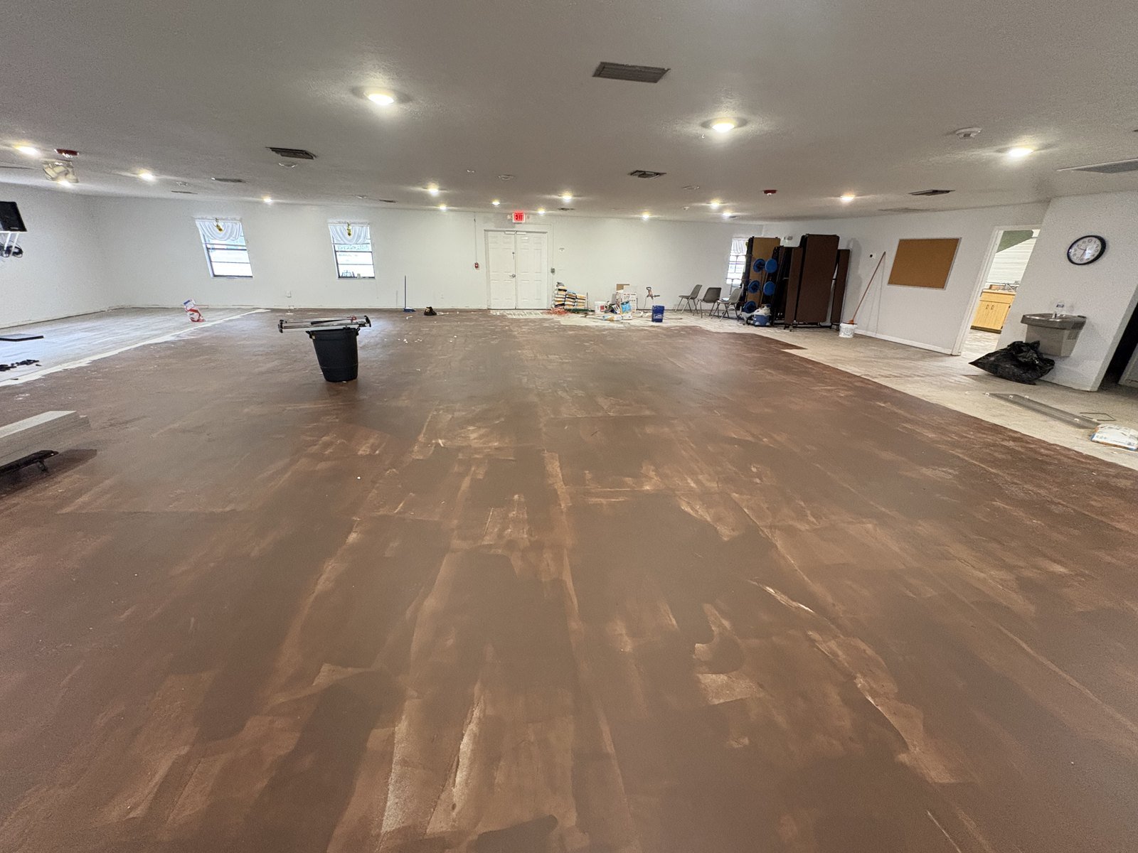 Church fellowship hall in Plant City with old vinyl removed and adhesive scraped off the concrete slab